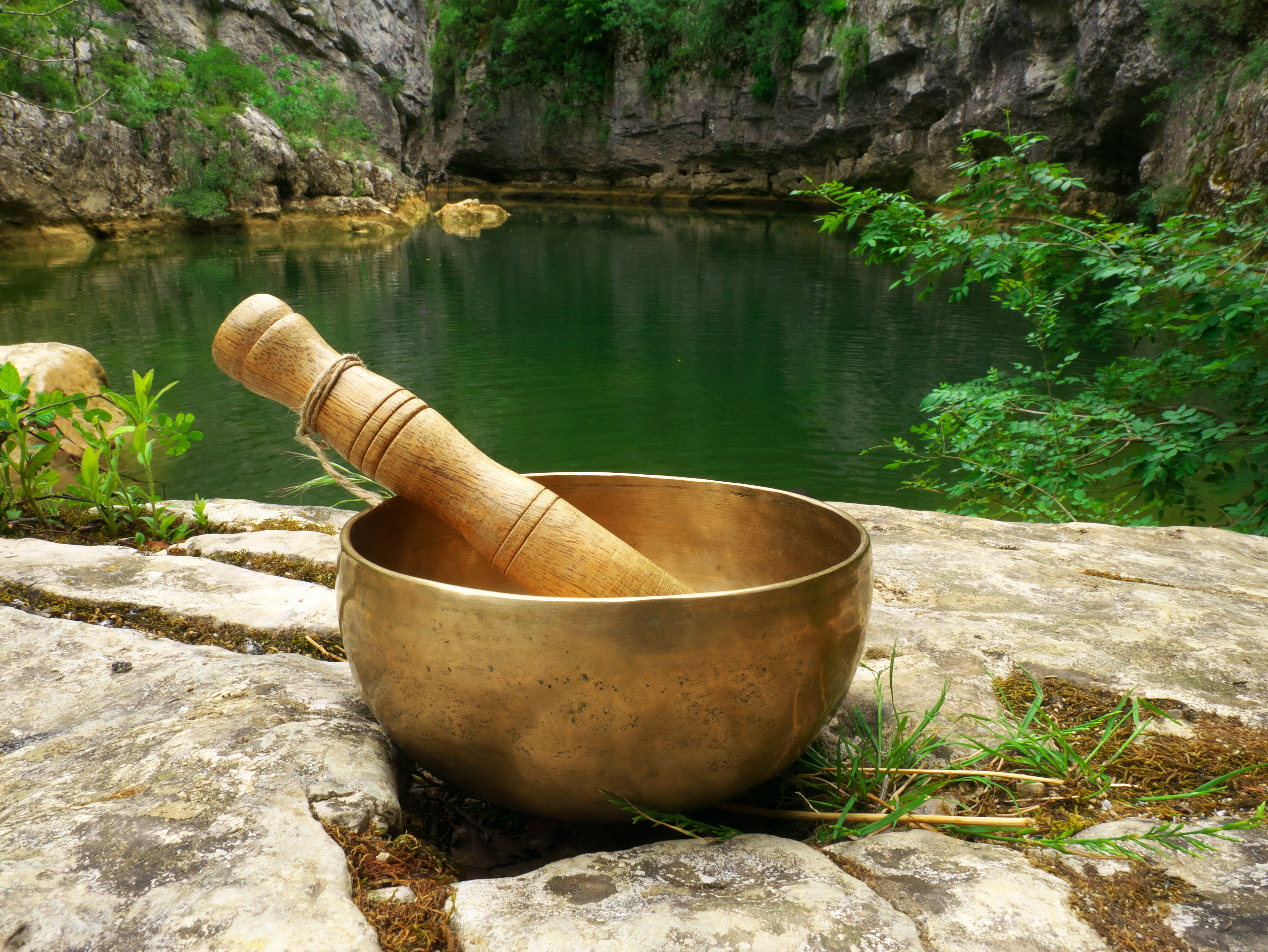 Closeup Of A Singing Bowl Placed In Nature With The River In The Background